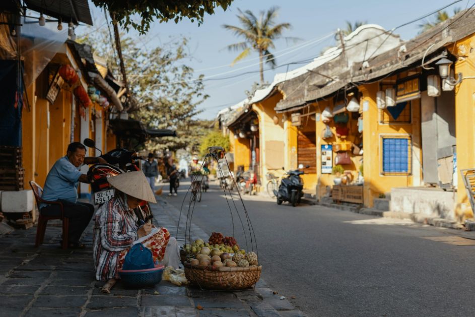 fruit vendor on a quiet street in Hoi An Old Town in Central Vietnam