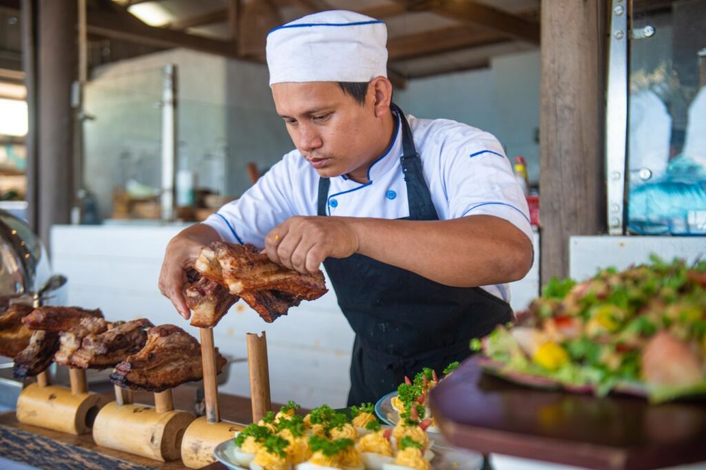 Chef at Shore Club carves roast pork meat for the Gourmet Sunday Easter Brunch at Shore Club An Bang Beach in Hoi An.