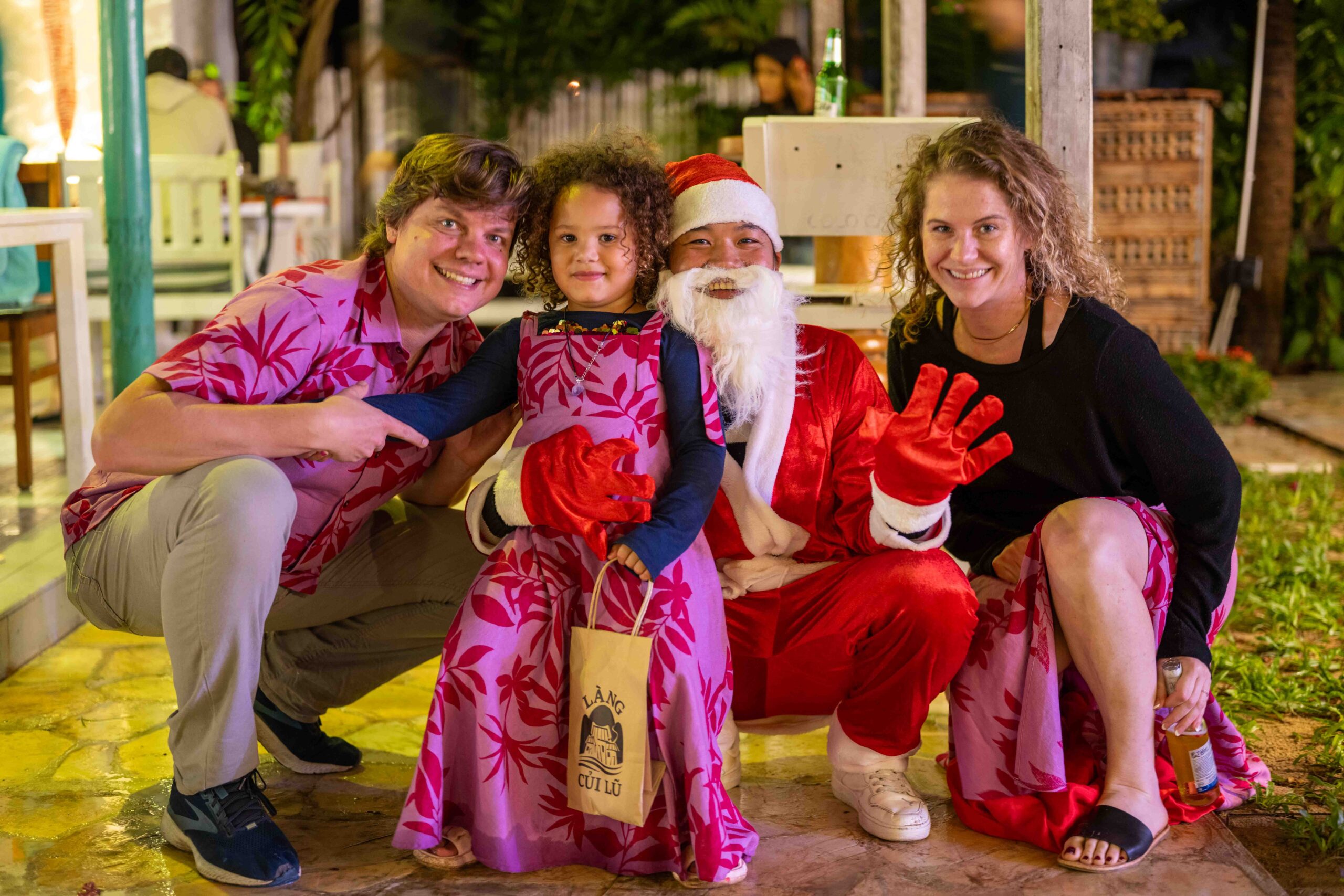 guests pose for a photo with Santa for Hoi An Christmas Event - Shore Club, An Bang Beach