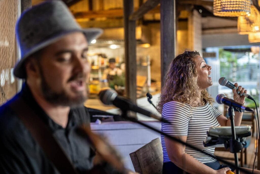 "Any Grooves band performing live on An Bang Beach, captivating the crowd with energetic music at Shore Club's New Year's Eve party."