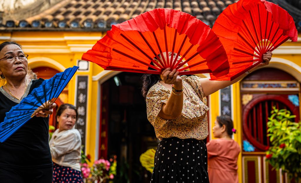 Traditional Vietnamese performance in Hoi An's Old Town, showcasing cultural dance and music against the backdrop of the historic streets.