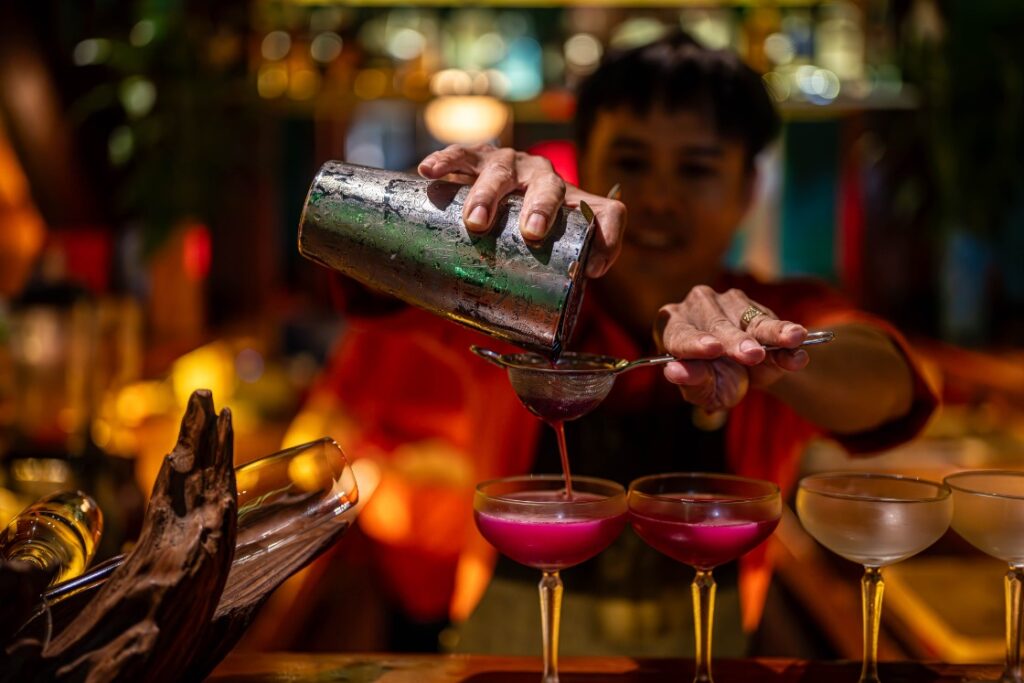 Mixologist crafting a creative secret cocktail using local ingredients for the SecretEATS Hoi An Cocktail Experience in Hoi An, Vietnam