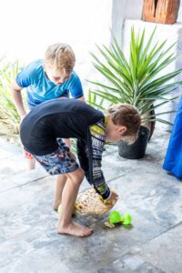 Young children searching for colorful Easter eggs at Shore Club, An Bang Beach, during the annual Easter Sunday celebration.